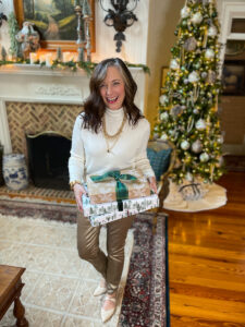 woman standing with presents in a dressy outfit