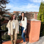 2 ladies standing by fence