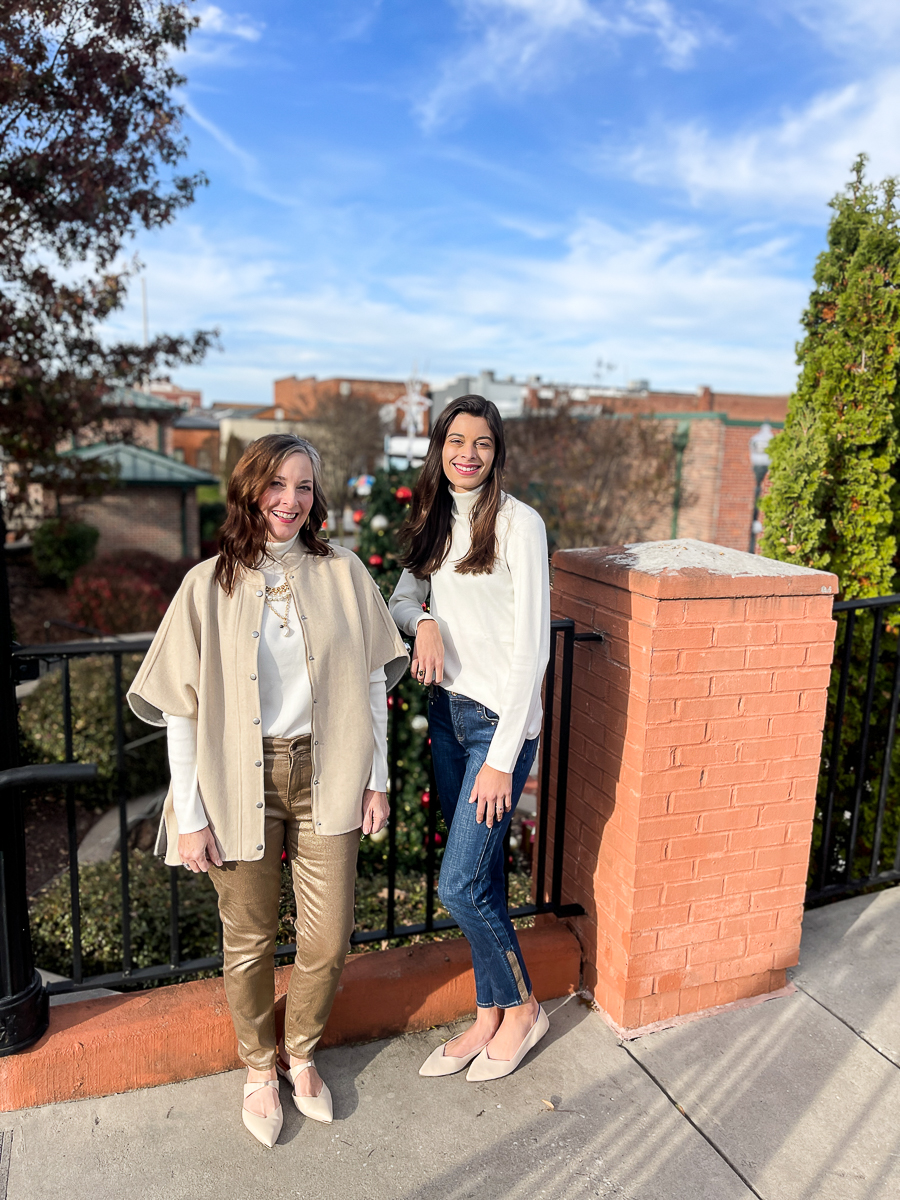 2 ladies standing by fence