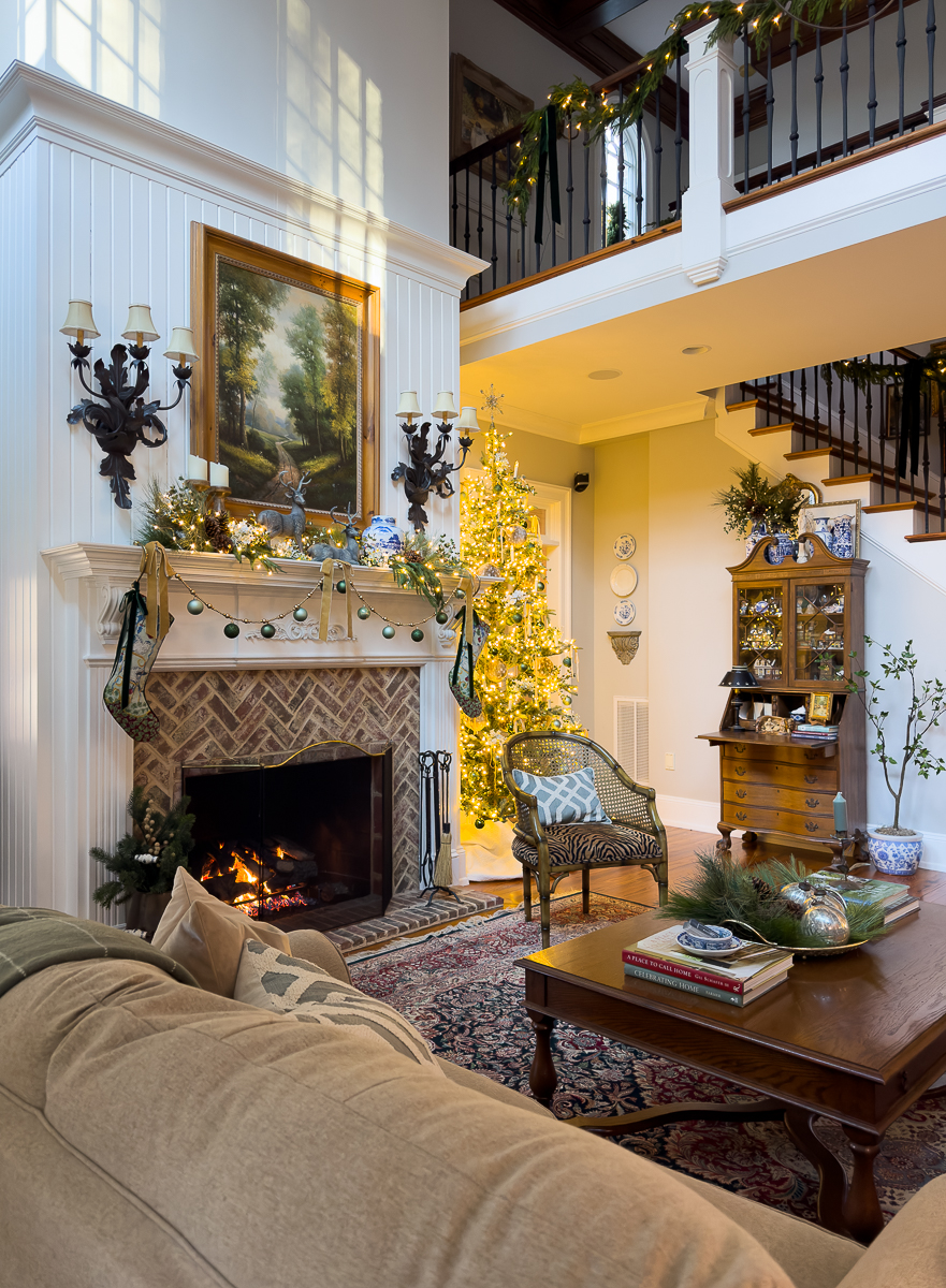side view of family room decorated for Christmas with blues, greens and tan