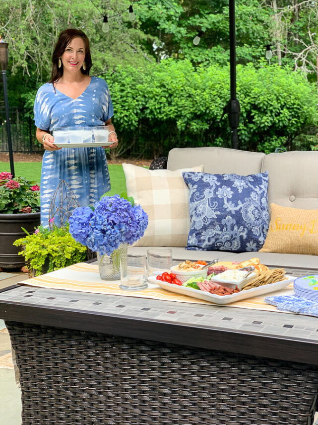 lady carrying drinks on porch