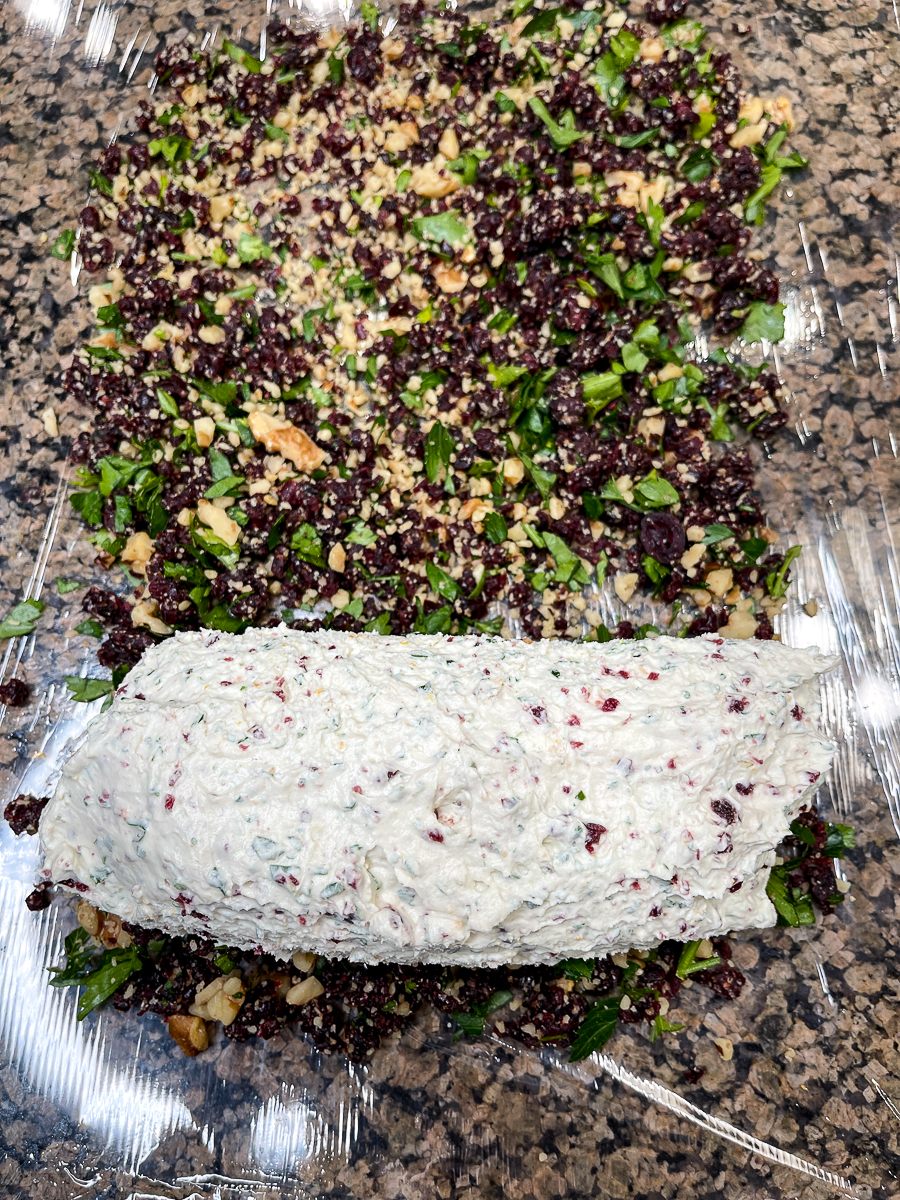 rolling a goat cheese log in cranberries