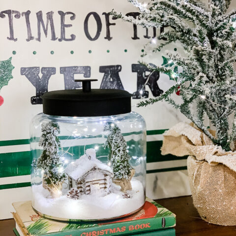 christmas scene in a cookie jar with fairy lights