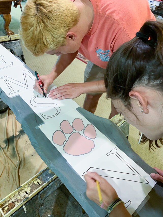 kids working on painted sign