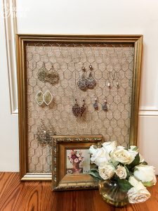 Thrift store framed art is easily turned into an earring organizer!