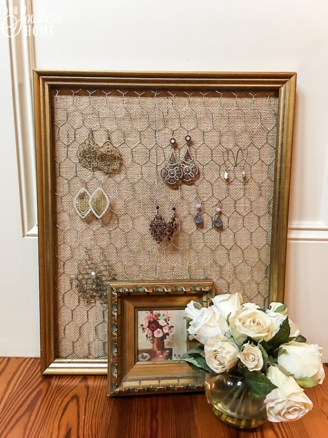 Thrift store framed art is easily turned into an earring organizer!