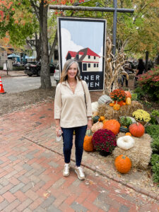 woman standing by pumpkins