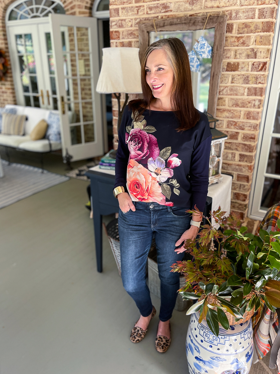 woman in floral tee and jeans