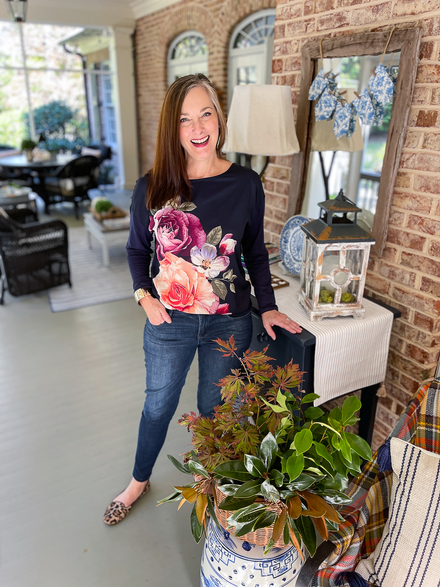 woman in floral tee and jeans