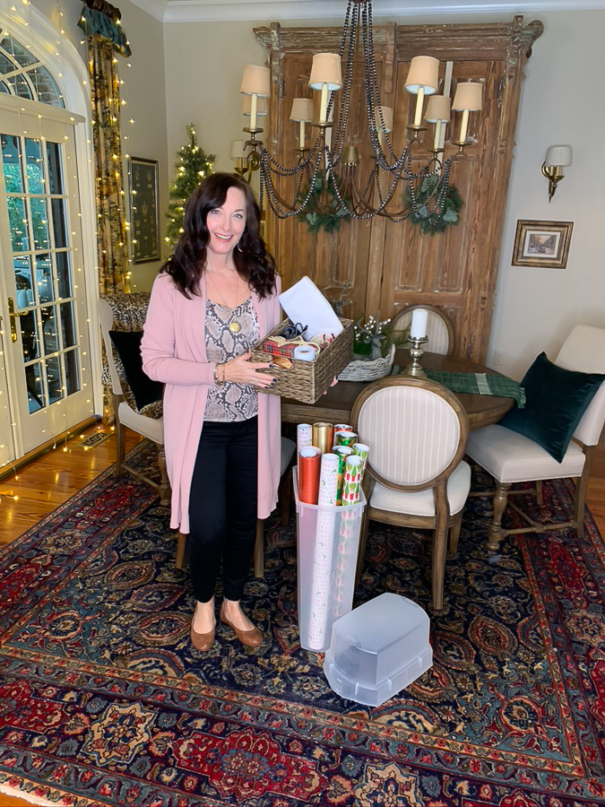 woman holding gift wrapping supplies