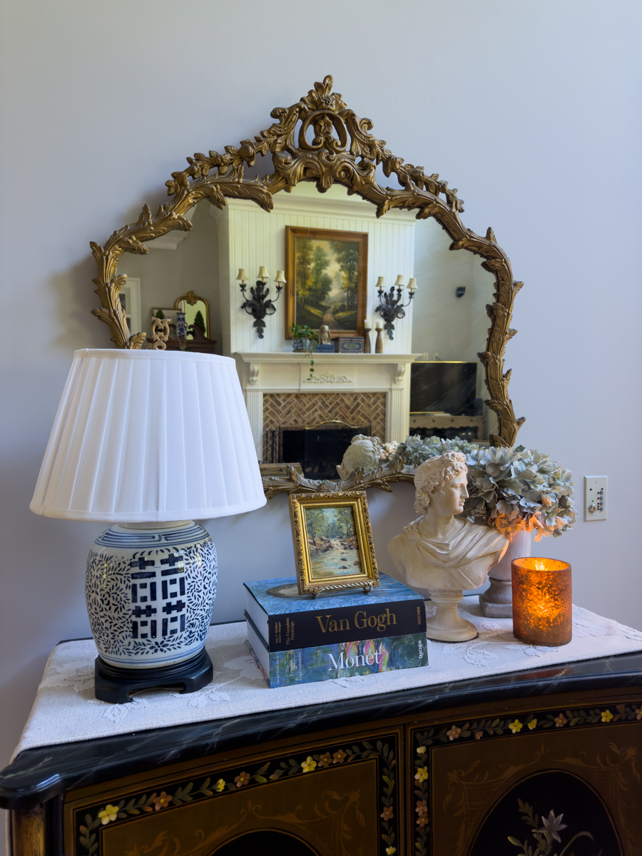 Thrifted ginger jar lamp styled on an antique cabinet in a traditional home