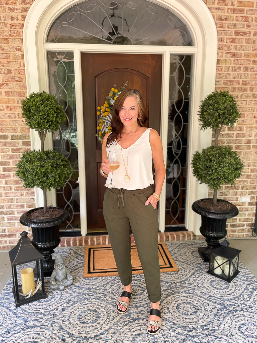 woman in green jogger on porch