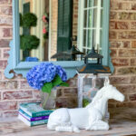 horse statue with flowers and mirror