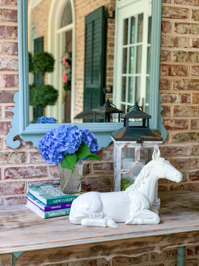 horse statue with flowers and mirror