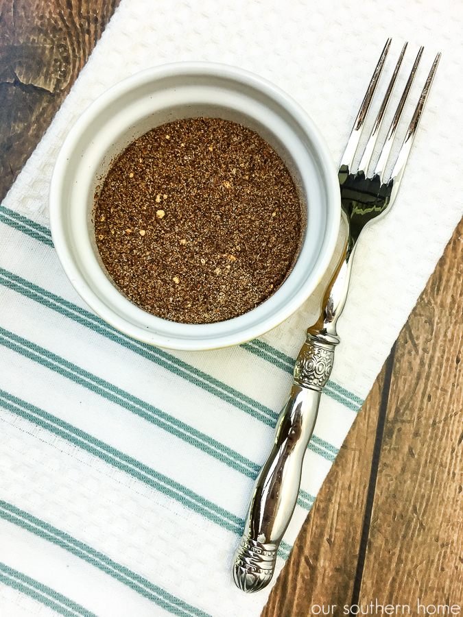 spices for chili on a striped towel with fork