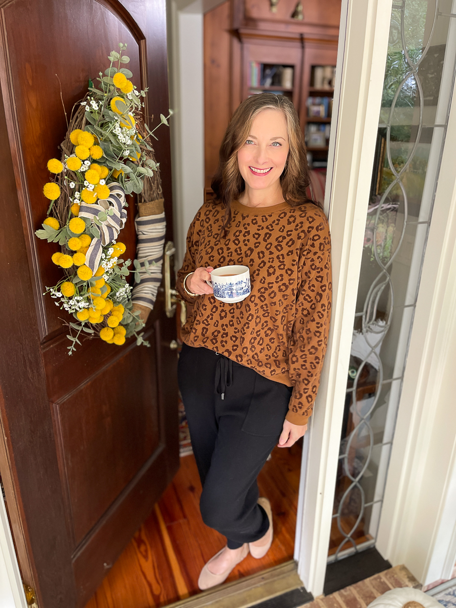 woman standing in doorway with mug