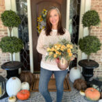 woman on porch holding flowers