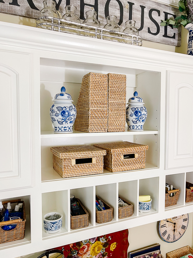 blue and white vases on shelf with baskets