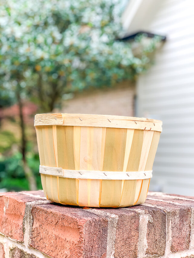 apple basket on a brick wall