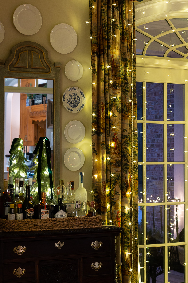 bar in dining room with widow curtain lights