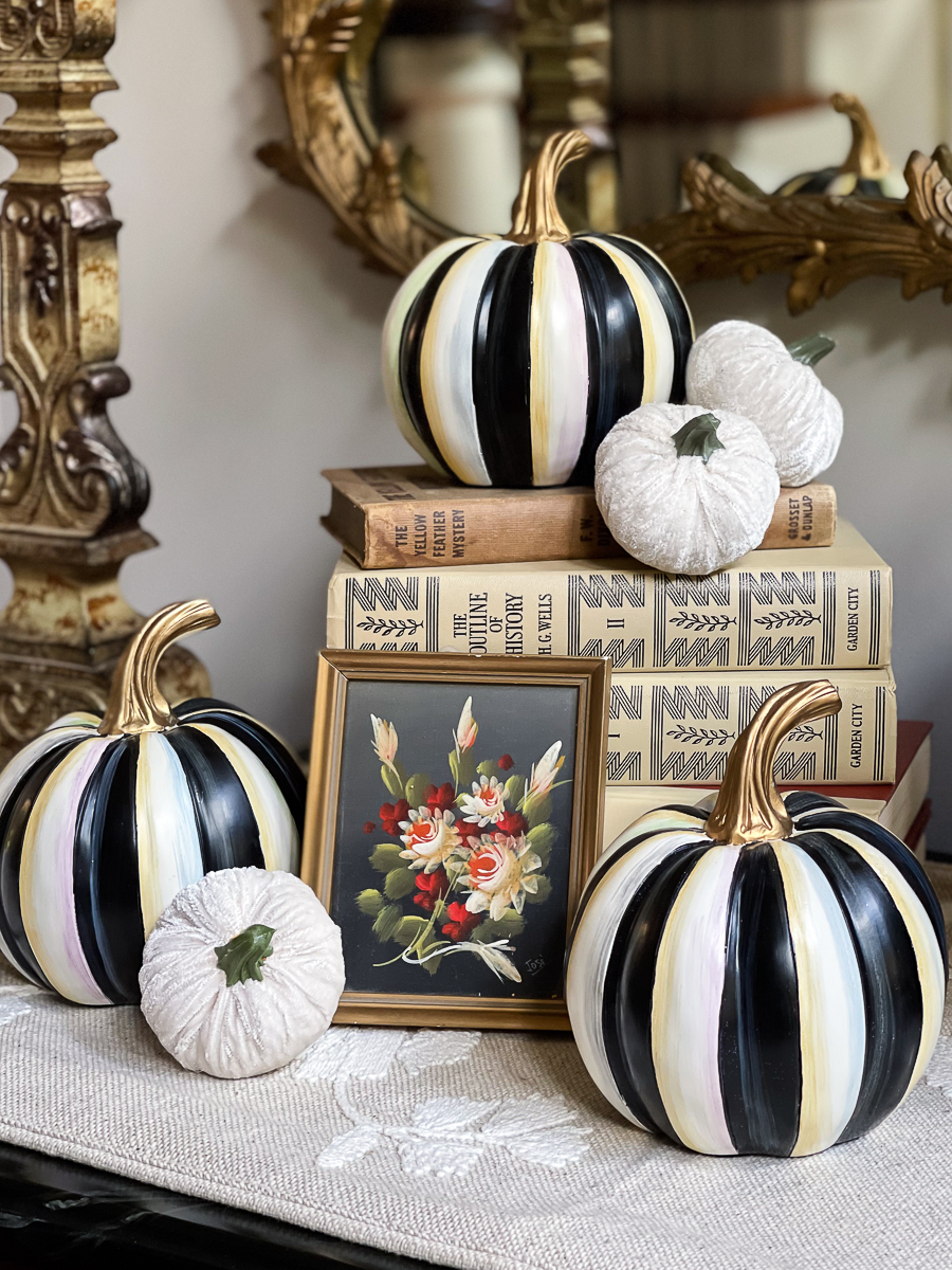 stacked books with pumpkins