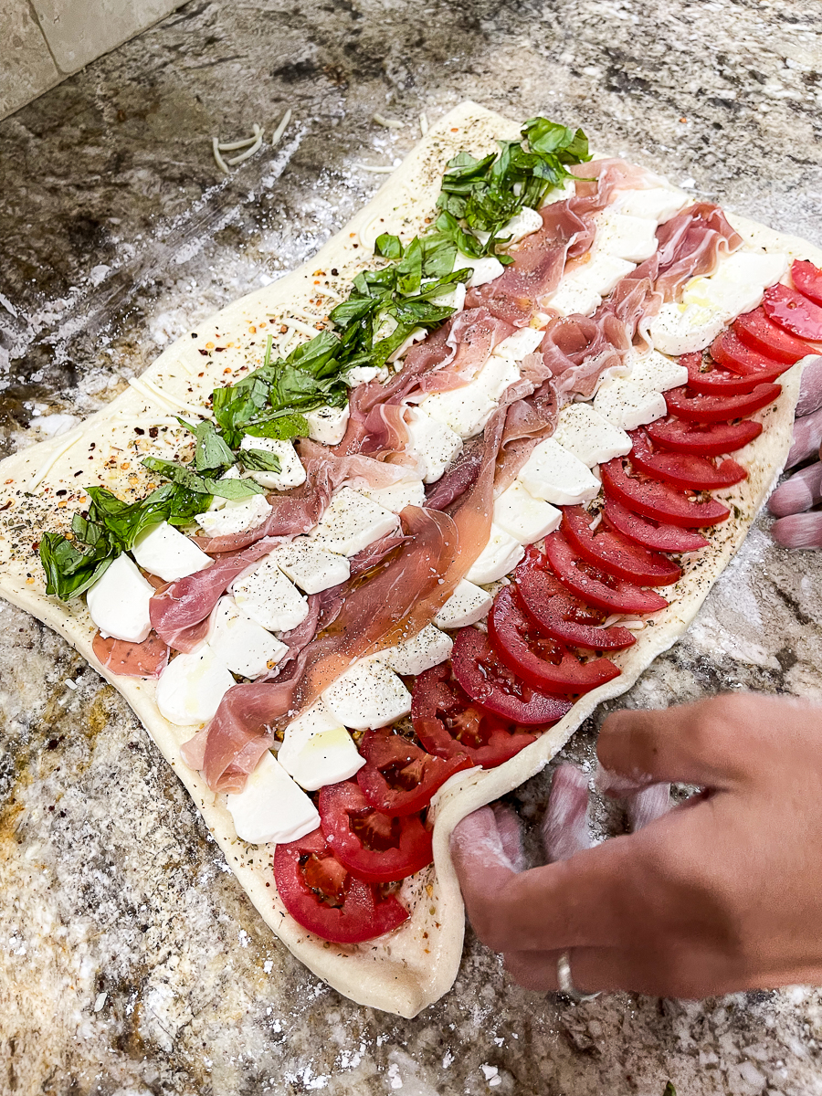 roll pizza dough with ingredients