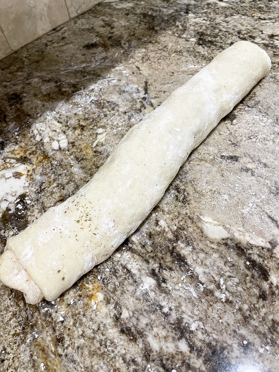 rolled log of pizza dough