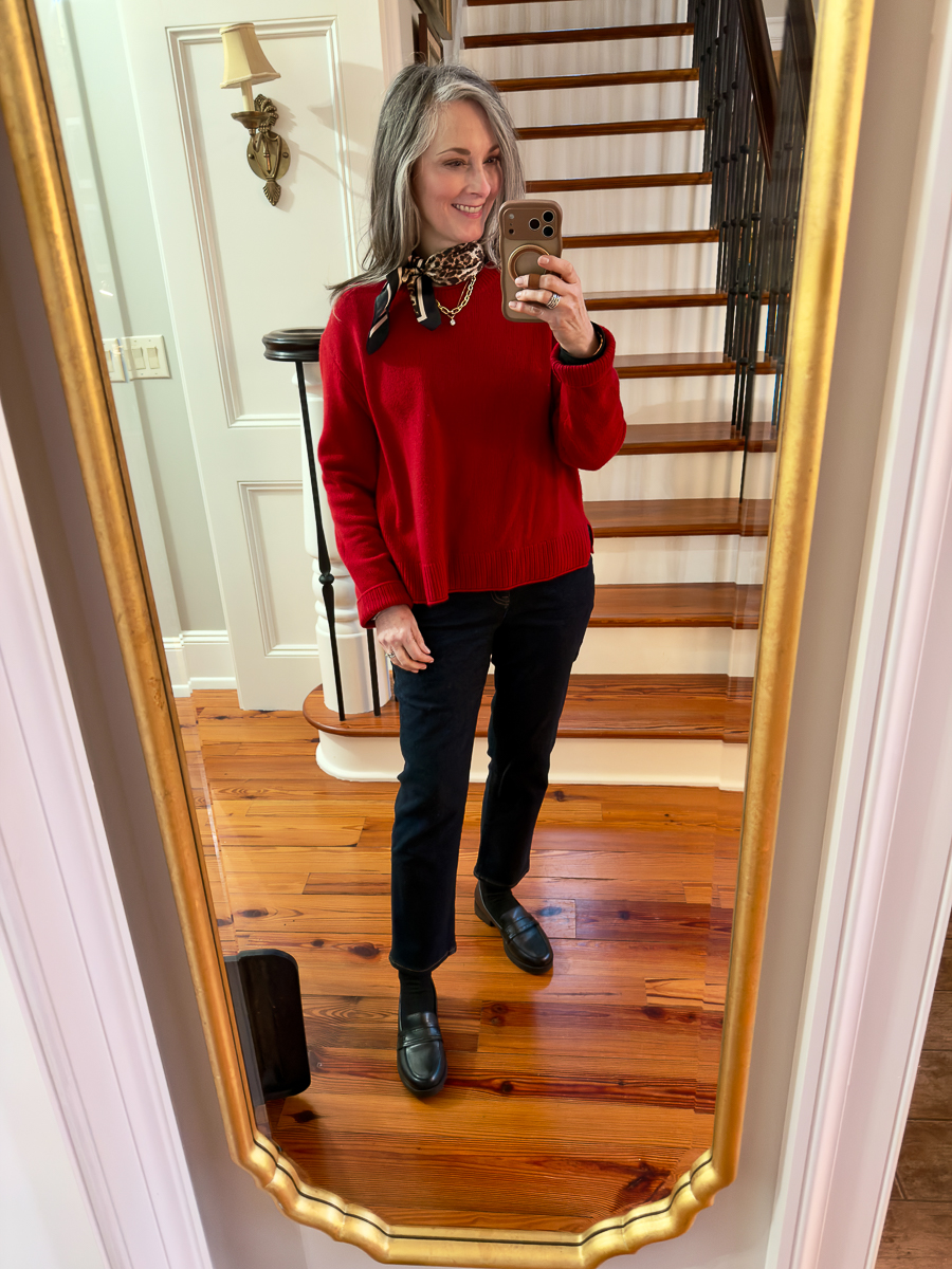 Woman wearing a red sweater styled casually at home