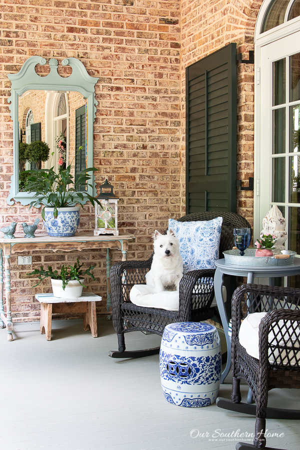 summer front porch with rockers and a white dog