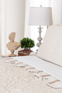 quilt folded down with a stripe pattern