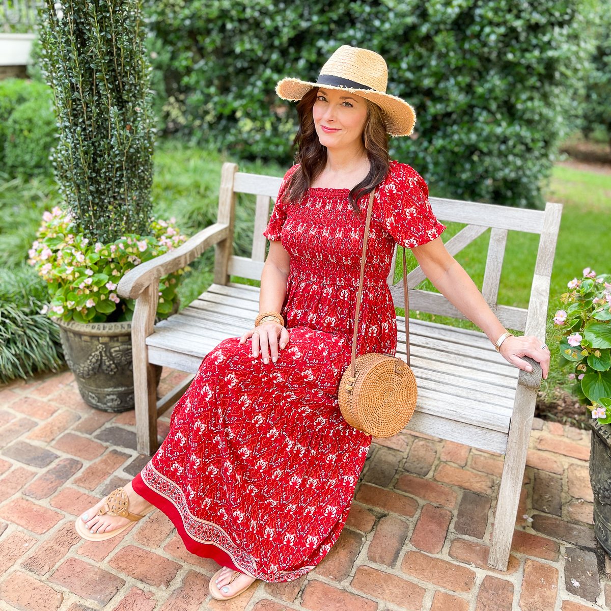 woman sitting in red dress and hat