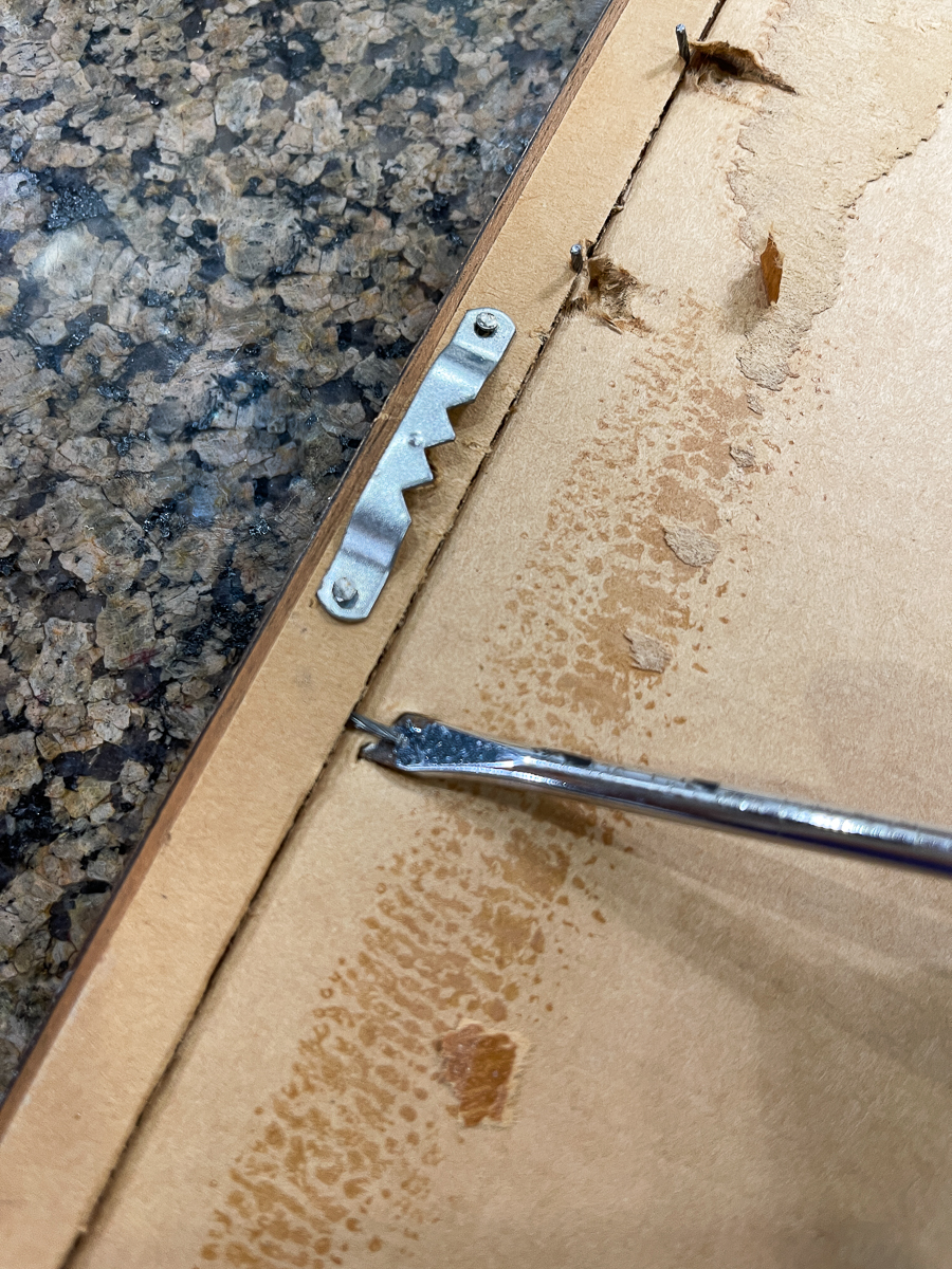 screwdriver removing staples