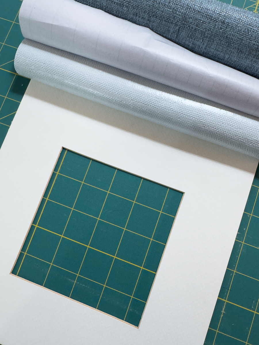 aligning grasscloth onto mat