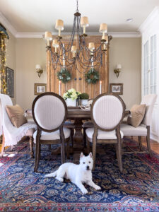 spring dining room with white dog on rug