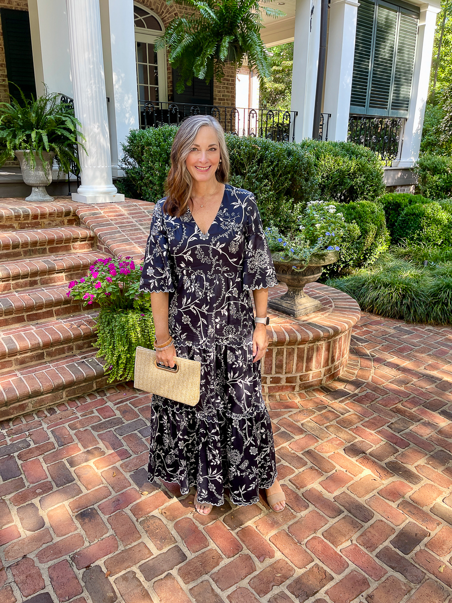 woman in dress with clutch bag