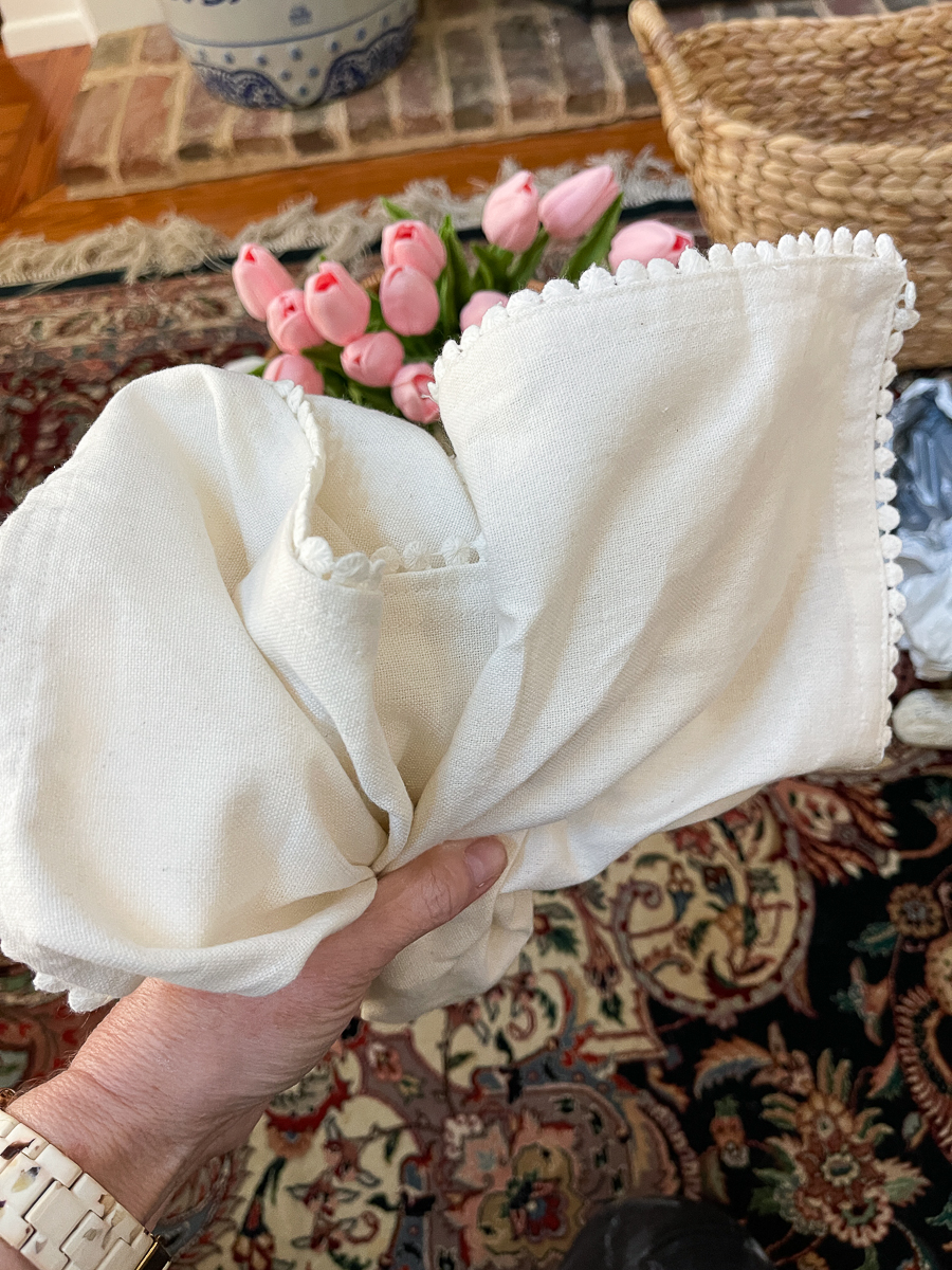 folded napkins with pom poms