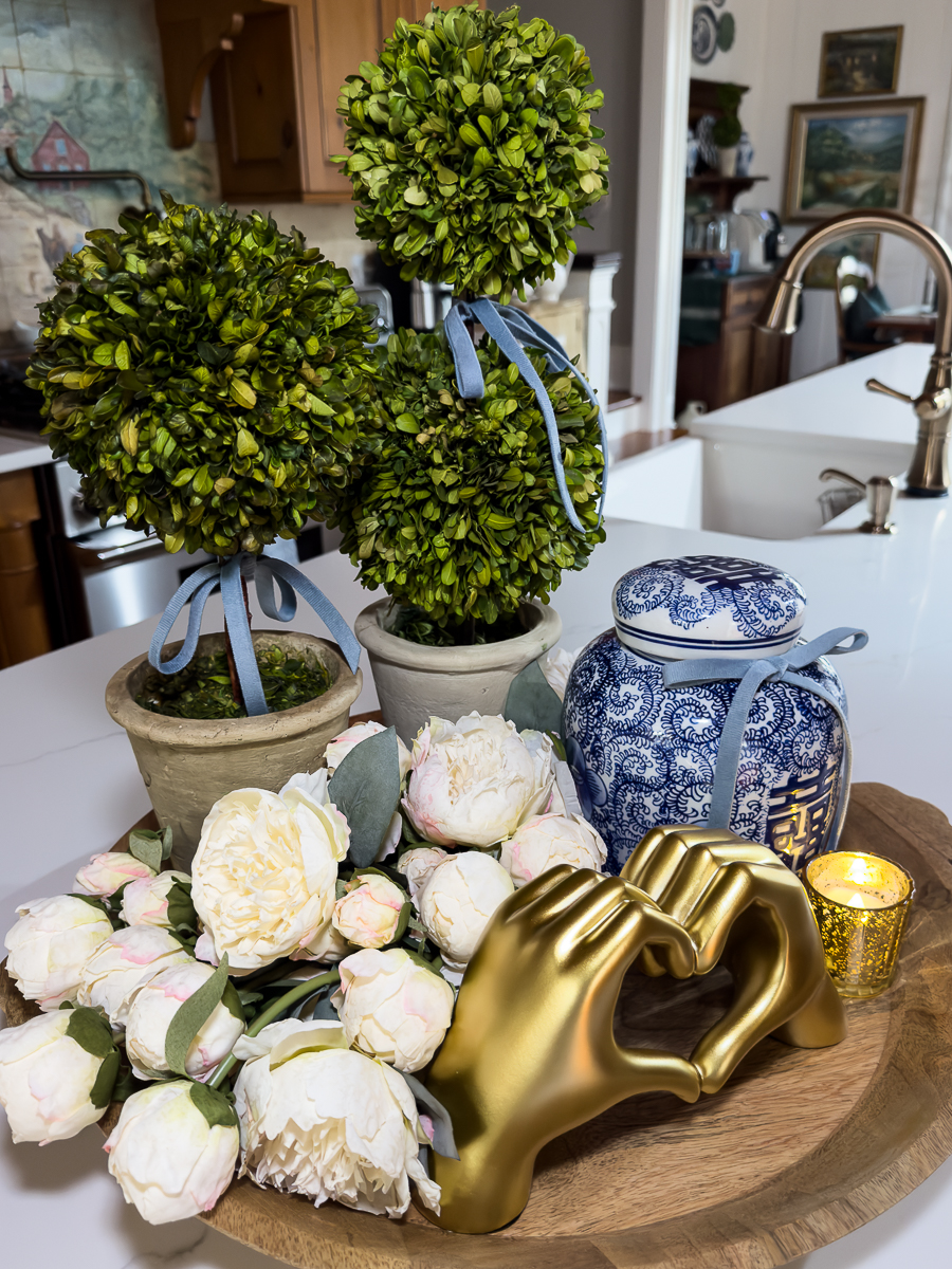 Valentine decor tray with gold heart hands sculpture and blush peonies.
