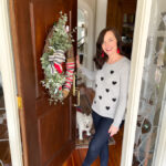 woman standing in doorway with dog