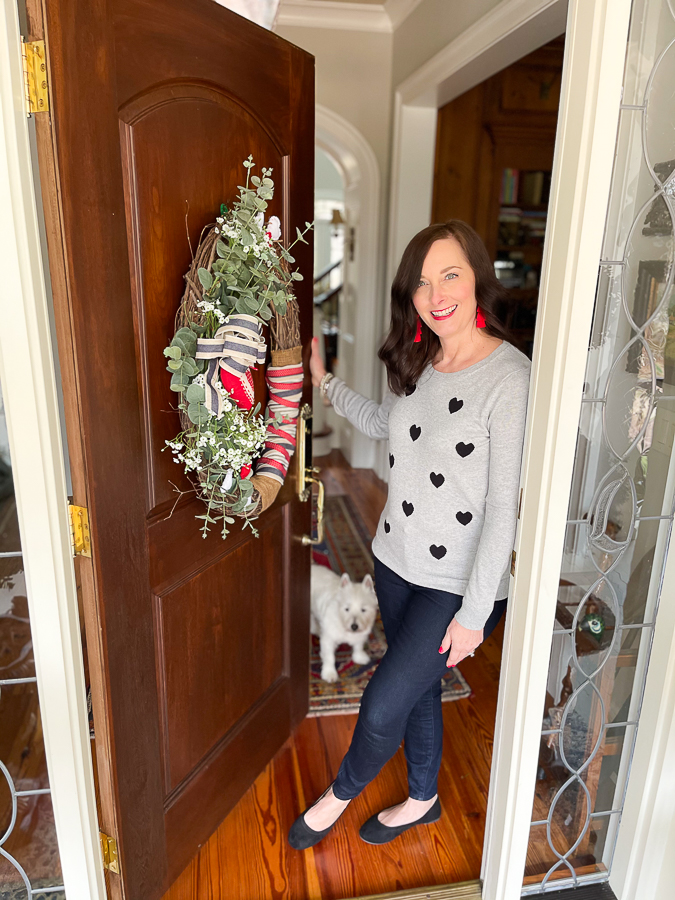 woman standing in doorway with dog