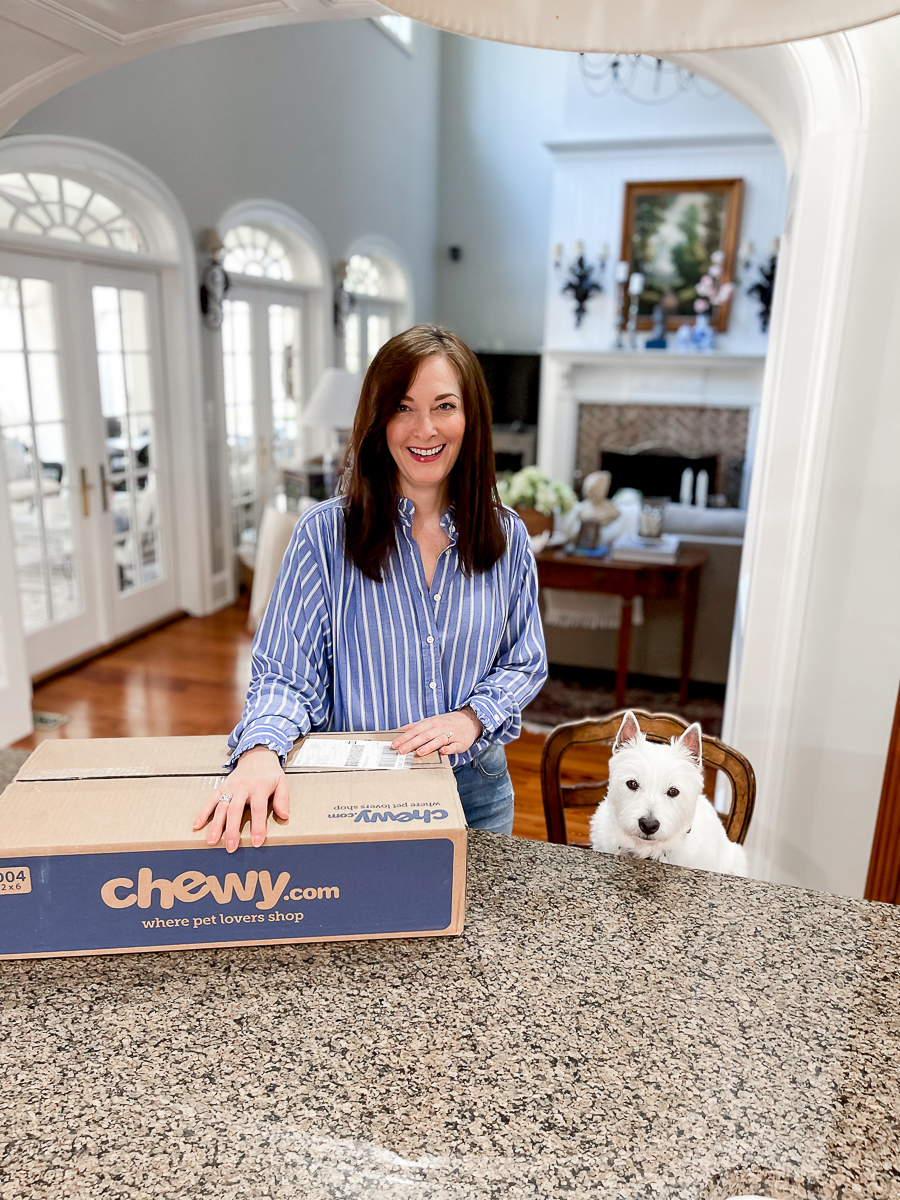 woman with dog and Chewy box