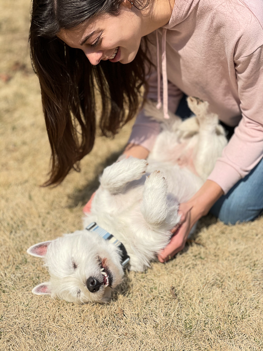 girl loving on dog