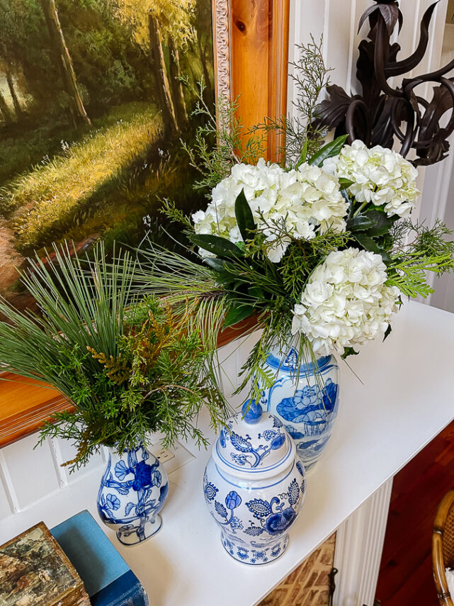 winter floral arrangement with blue and white porcelain on mantel