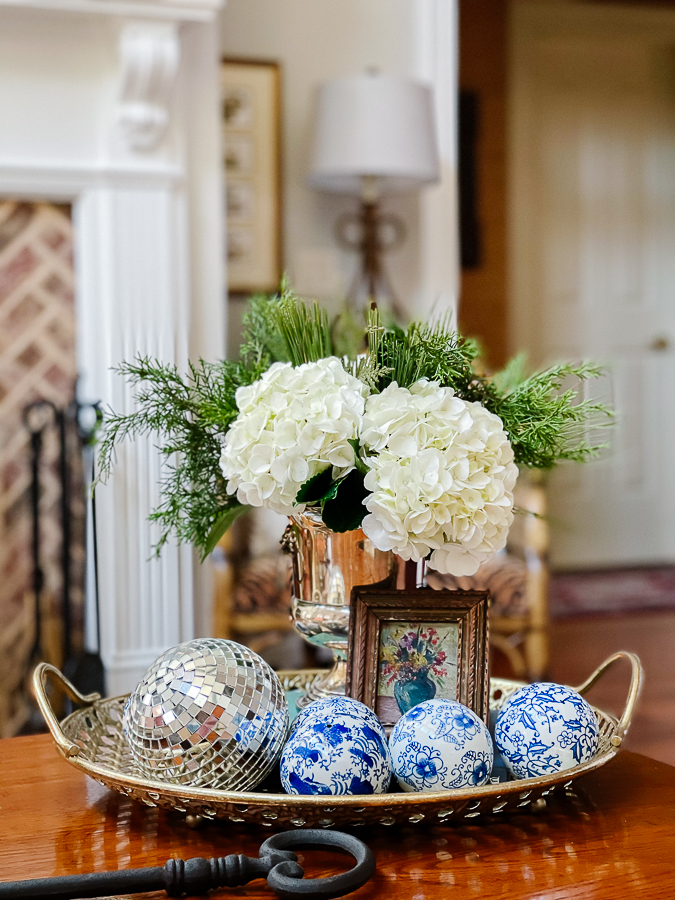 winter floral arrangement with blue and white porcelain balls and small oil