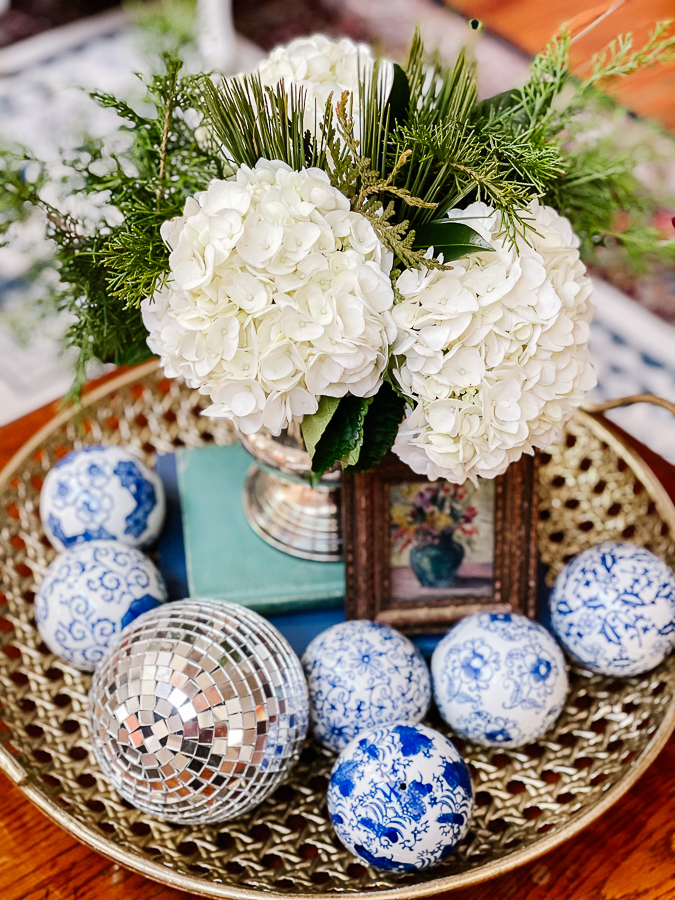 winter floral arranging with blue and white porcelain on a brass tray